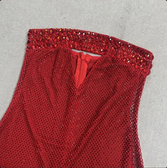 Close-up of the strapless neckline and zipper detail on the crystal gown