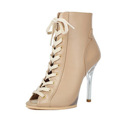Beige high-heeled shoe with lace-up design on a white background