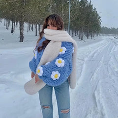 A woman wearing a cozy handmade flower cardigan with an open stitch design and puff sleeves.  Golden Atelier 5