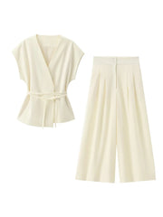 White sleeveless top and wide-leg pants set on a white background