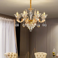 Luxury chandelier hanging in a room with neutral walls and decorative elements.