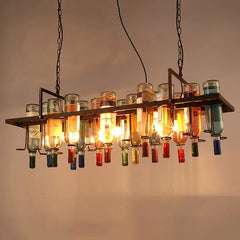 Chandelier made from repurposed wine bottles with colorful glass shades against a neutral background.
