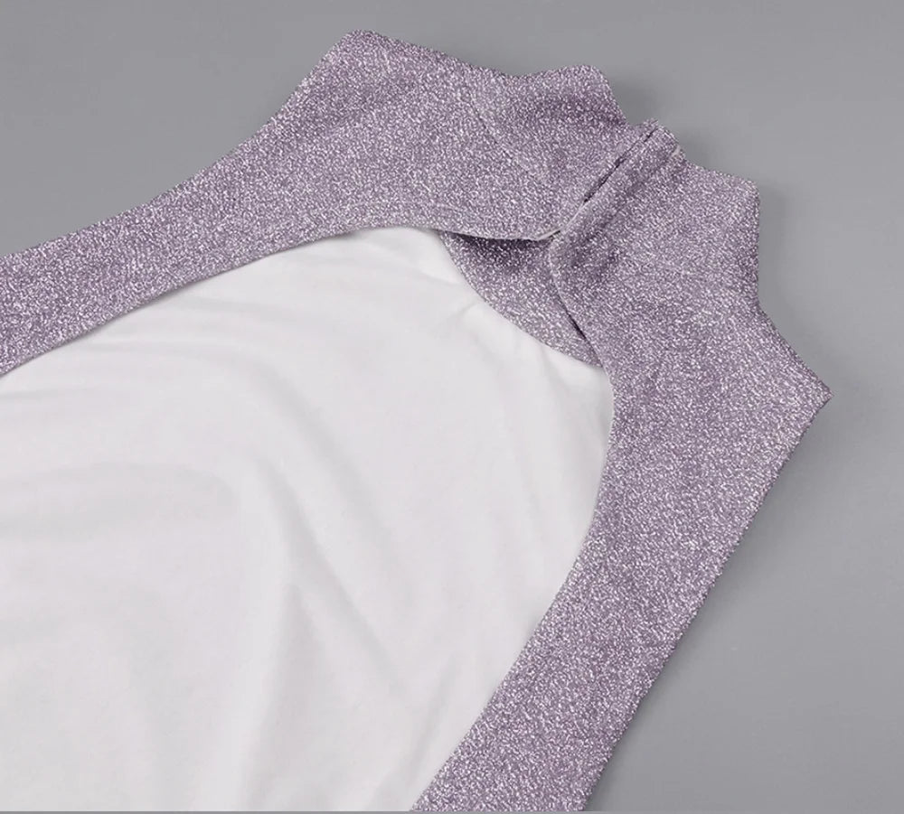 Close-up of a purple glittery fabric edge on a white background