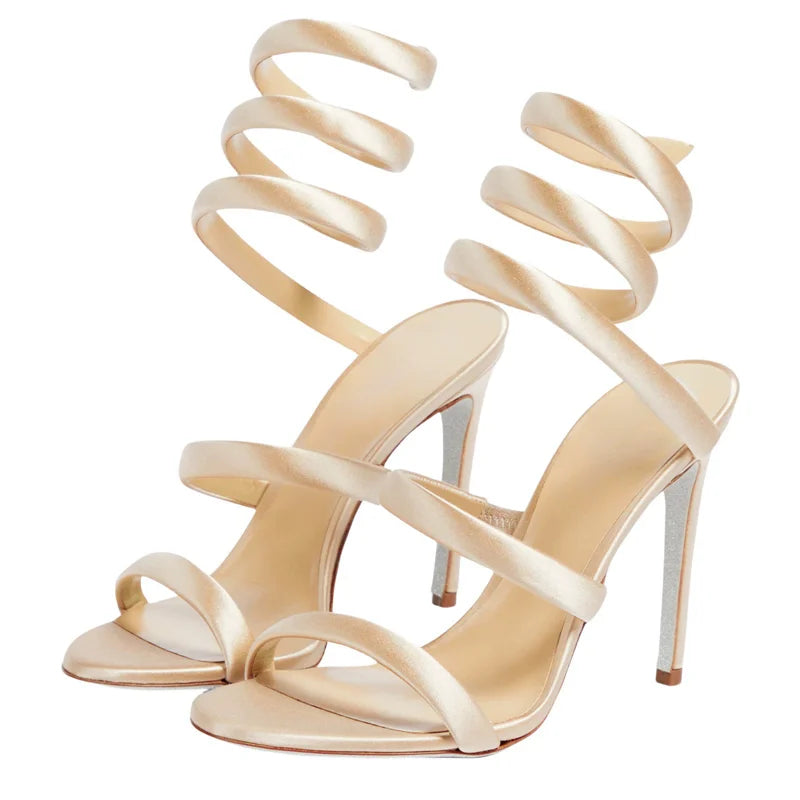 Beige high-heeled sandals with spiral straps on a white background