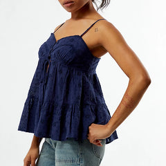 Navy blue lace top worn by a person on a white background