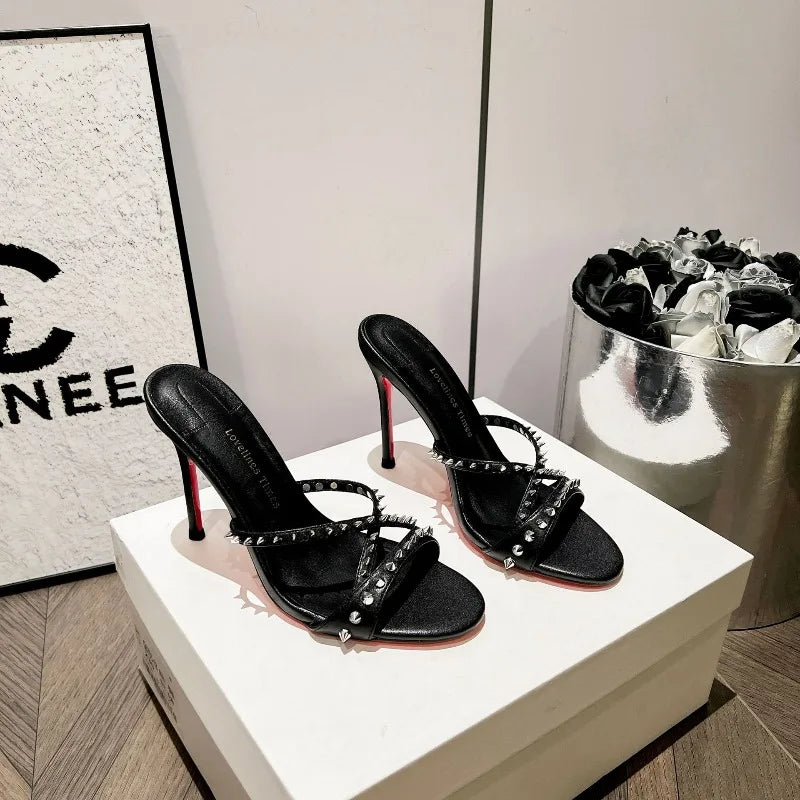 Pair of black studded strap stiletto heels