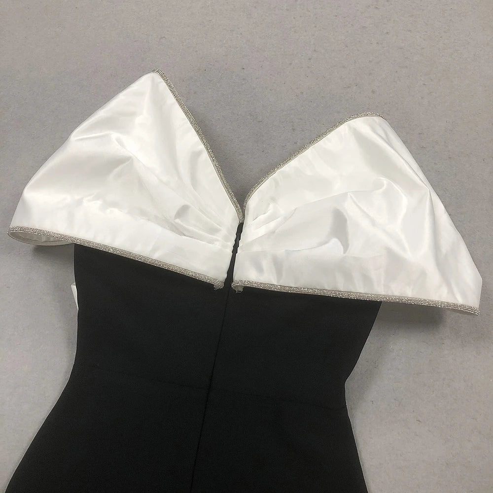 Black dress with white satin collar on a gray background