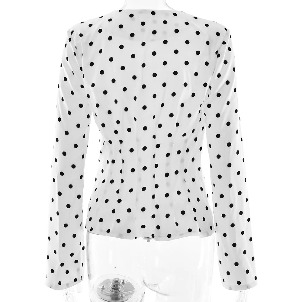 White blouse with black polka dots on a white background