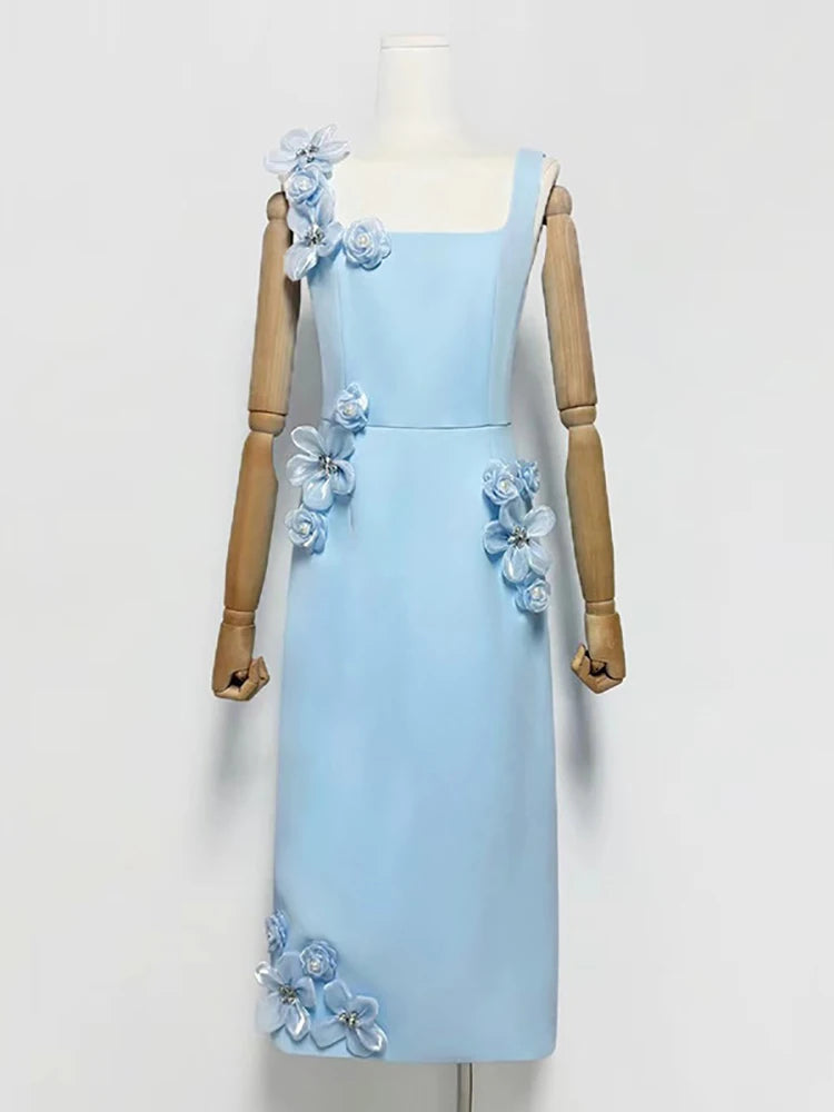 Light blue dress with floral embellishments on a mannequin against a white background