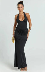 Black halter neck ruched waist maxi dress with gold clutch