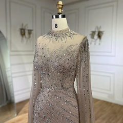 Mannequin  displaying  the beaded lace mermaid gown with cape sleeves, showcasing its elegant silhouette and train. Golden Atelier 4