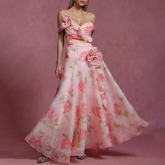 Woman wearing a pink floral dress against a matching pink background