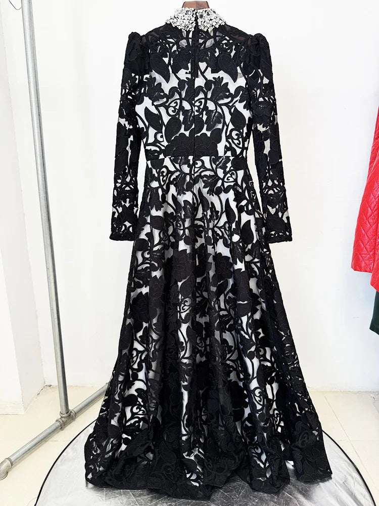 Back view of black embroidered mesh maxi dress with beaded collar on a hanger.