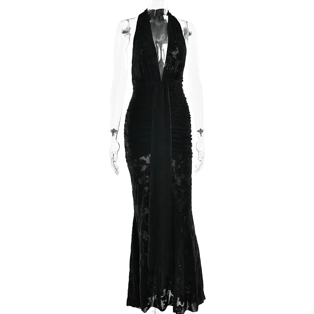 Black evening gown on a mannequin against a white background