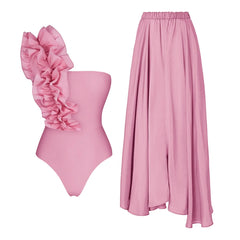 Two-piece pink swimsuit set with ruffled one-shoulder top and maxi skirt.