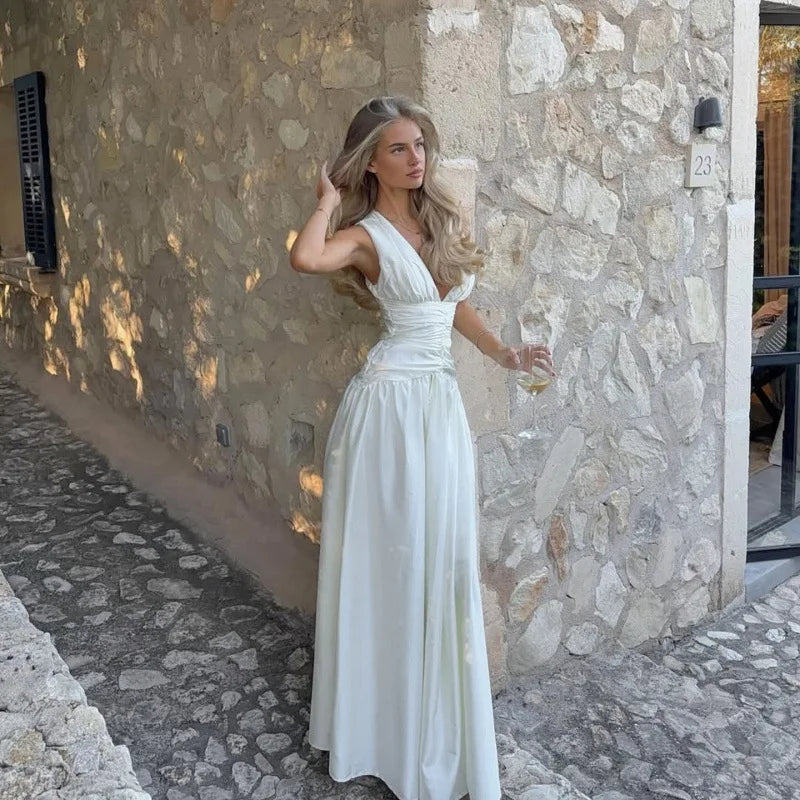 White deep V-neck ruched waist maxi dress with flowing skirt