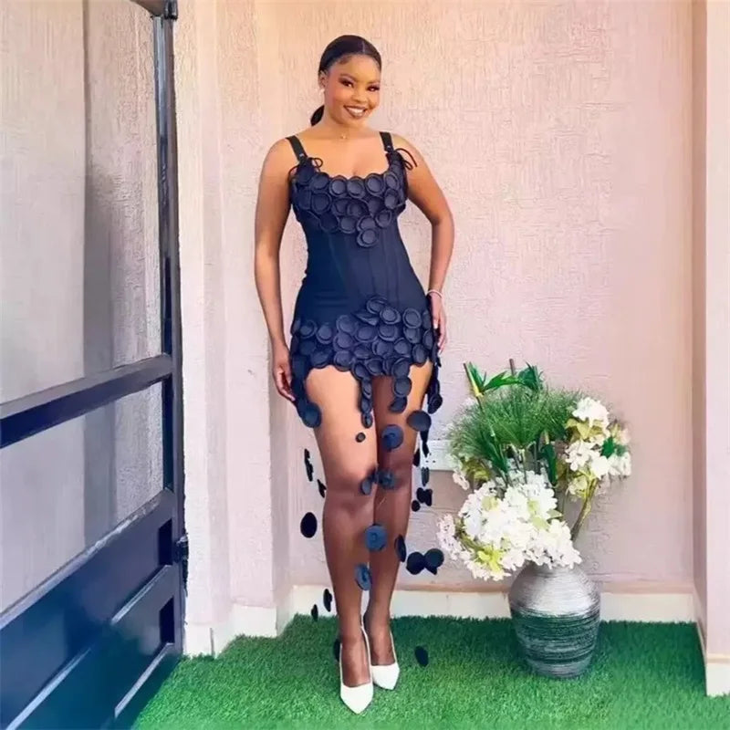 Woman wearing a black mini dress with circular appliqués and hanging embellishments