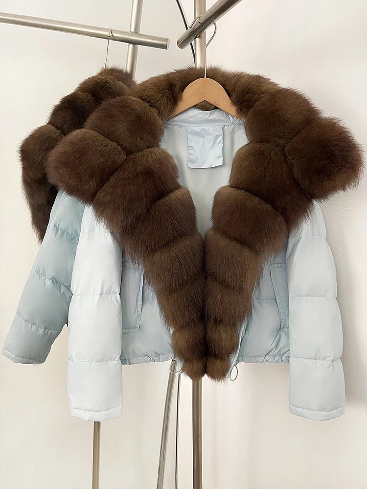Light blue puffer jacket with brown fur collar on a hanger against a white background