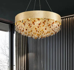 Gold chandelier with crystal accents hanging in a modern interior setting.