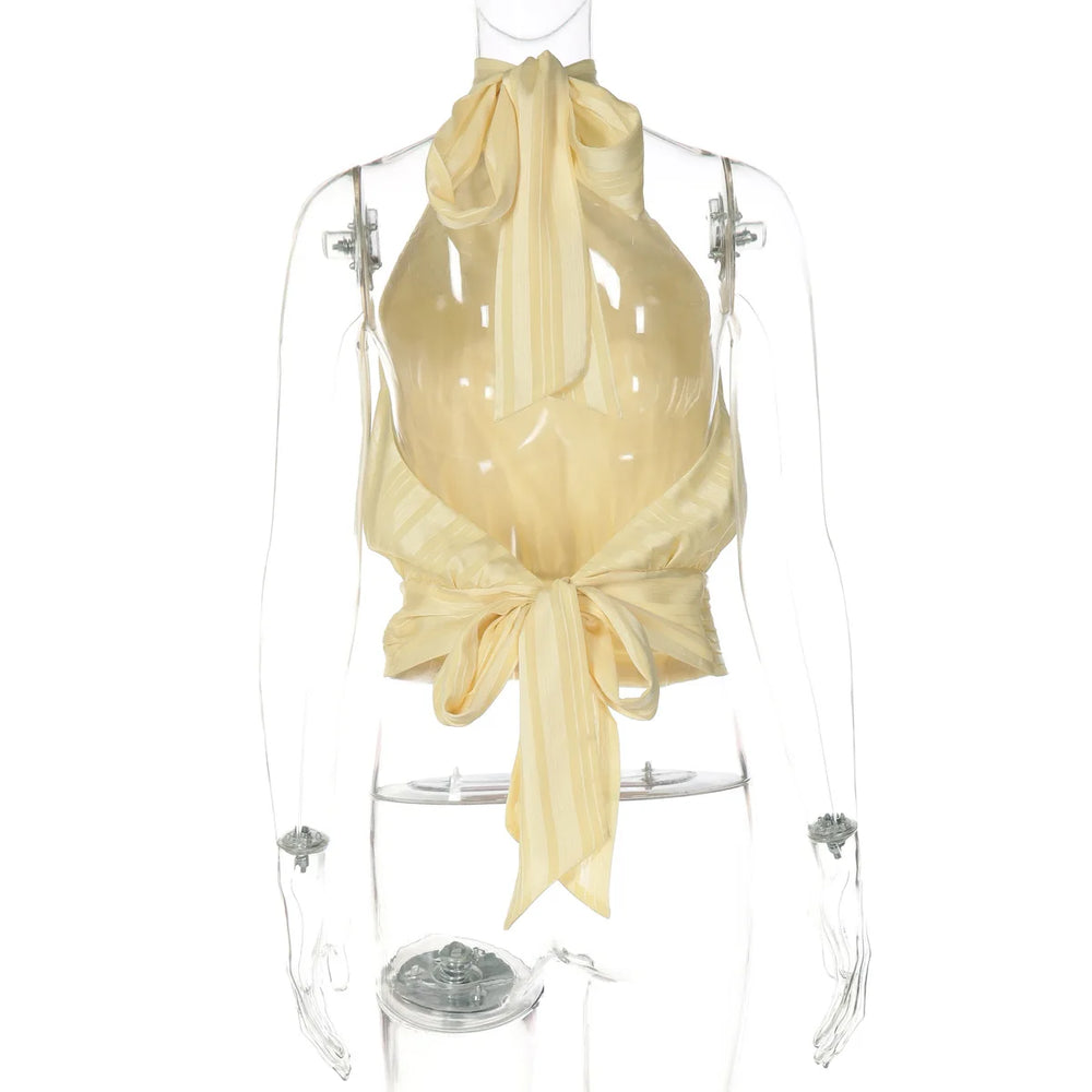 Mannequin wearing a beige halter top with a bow detail on a white background