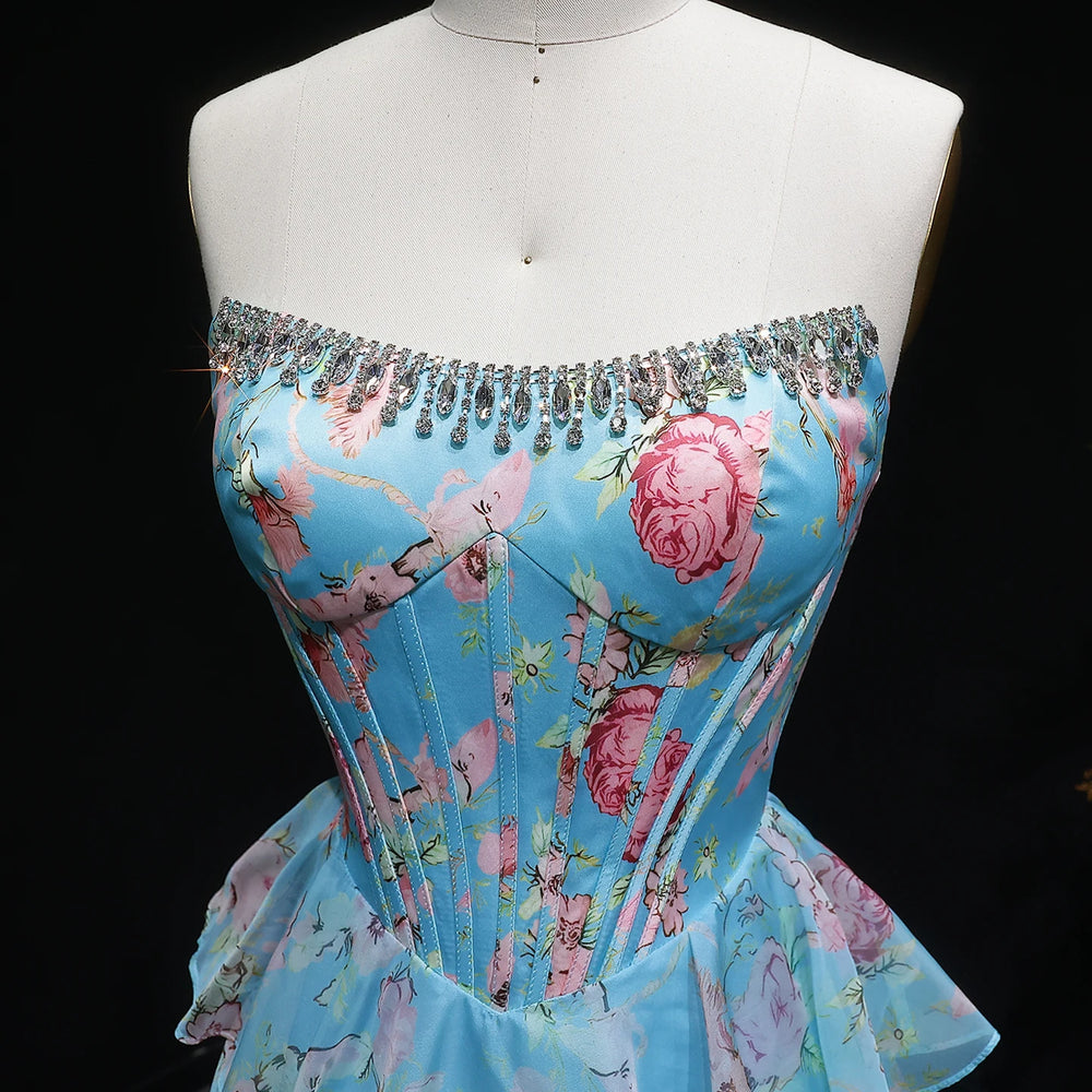Blue floral dress with beaded neckline on a mannequin against a black background