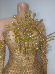 Close-up of golden eye embellishment on bodysuit
