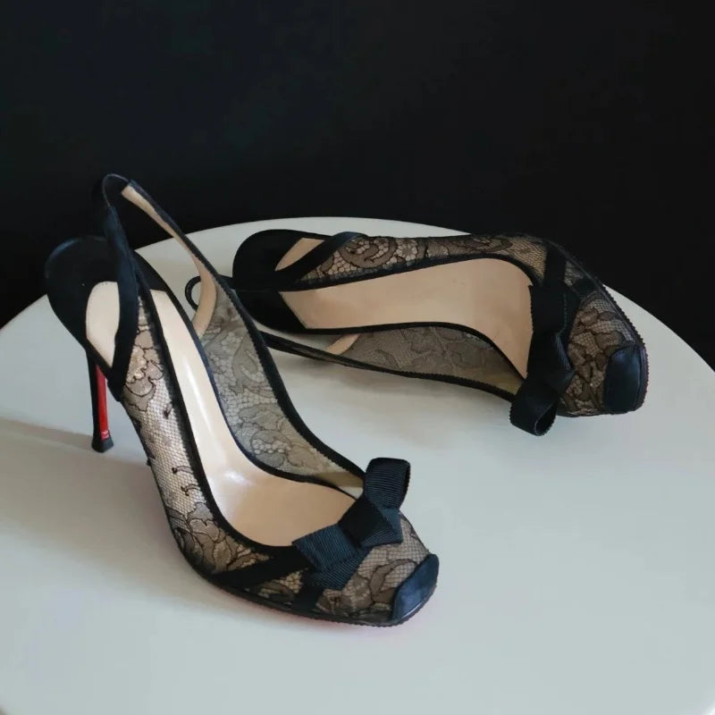 Bottom view of black lace slingback heels showing sole