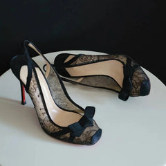 Bottom view of black lace slingback heels showing sole