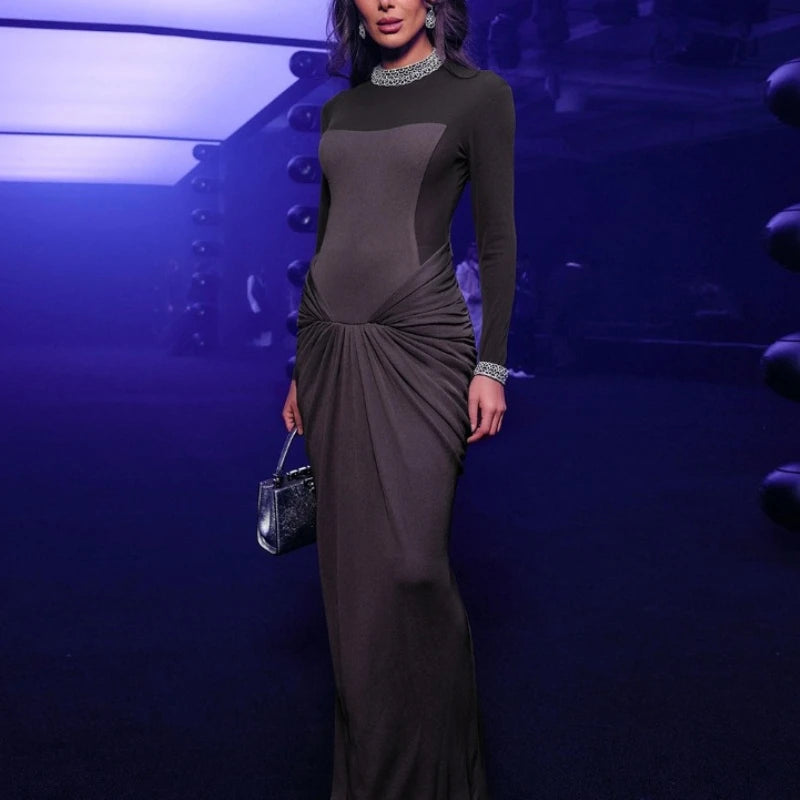 Floor-length contrast panel gown styled for a night event.