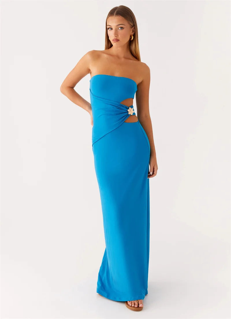 Woman wearing a blue strapless gown with cut-out design on a white background