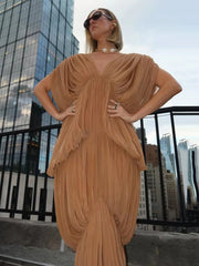 Close-up of gauze drape v-neck dress on model with city skyline