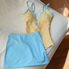 Yellow gingham print one-piece swimsuit with blue cover-up skirt detail