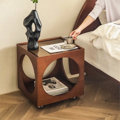 A minimalist Scandinavian corner table crafted from solid wood, placed in a cozy living room corner. B