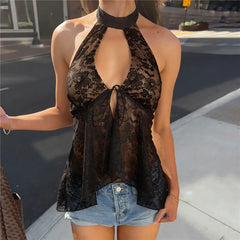 Model wearing a black floral lace halter crop top with denim shorts.