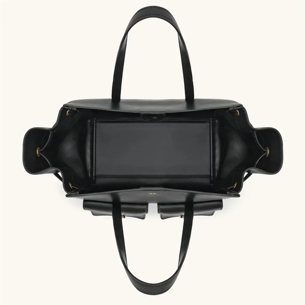 Black handbag with a reflective surface on a white background