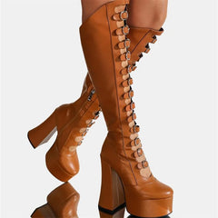Tan knee-high platform boots with detailed design on a white background