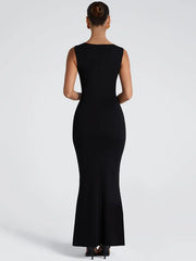 Woman wearing a black sleeveless dress on a white background