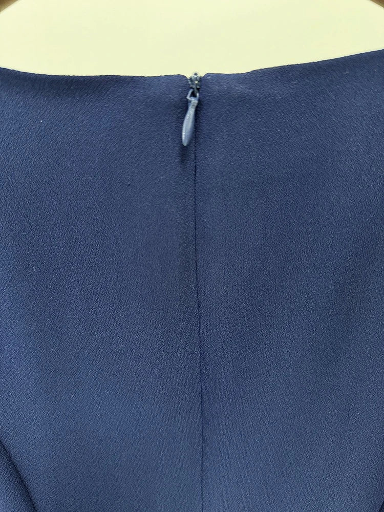 Close-up of a blue fabric with a zipper on a beige background