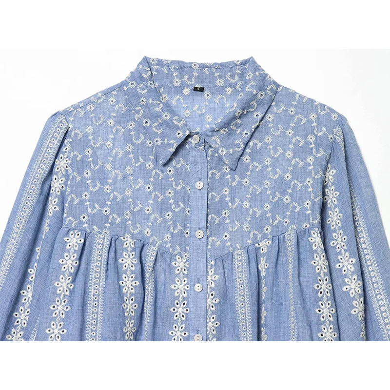 Close-up of embroidered lapel collar on blue blouse