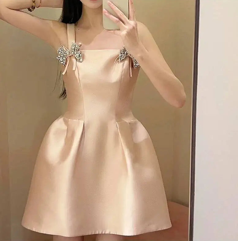 Diamond bow embellished strap square neck mini dress pose