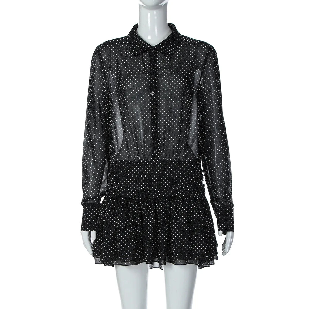 Black polka dot dress on a mannequin against a white background