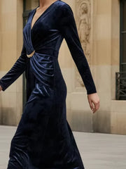 Navy velvet dress worn by a model in an indoor setting