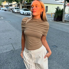 Khaki draped turtleneck short sleeve cropped top worn outdoors