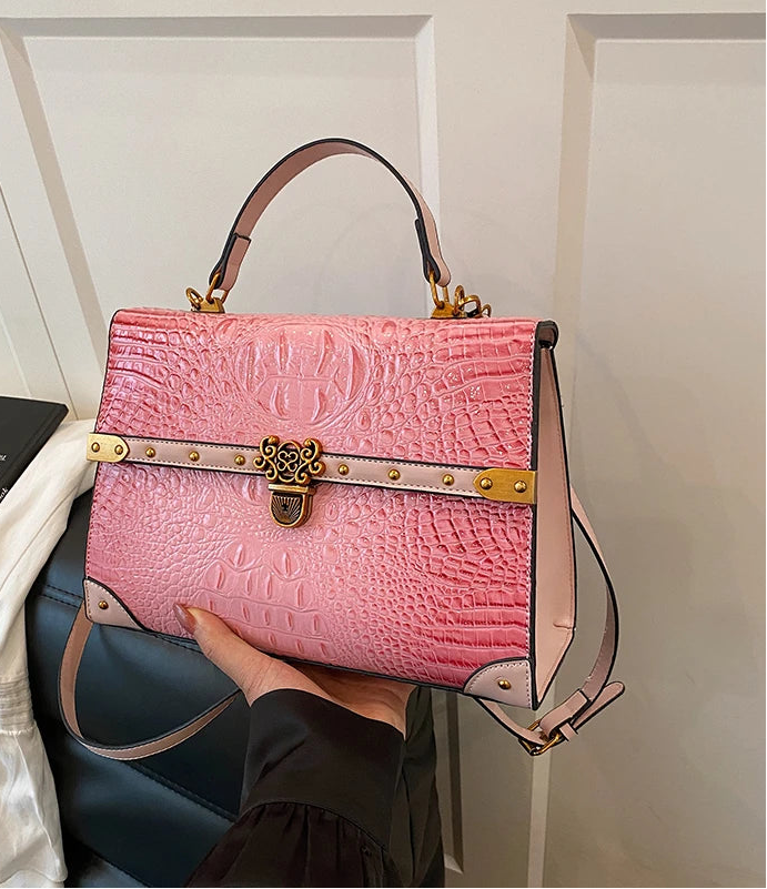 Close-up of pink crocodile embossed bag detail