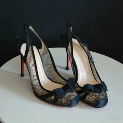 Black lace slingback heels with floral pattern and bow