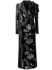 Full length view of black sequined floral blazer and split skirt suit