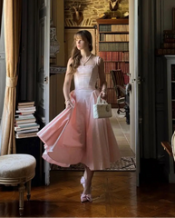 Woman wearing a pink A-line sleeveless cotton midi dress with square neckline, summer fashion
