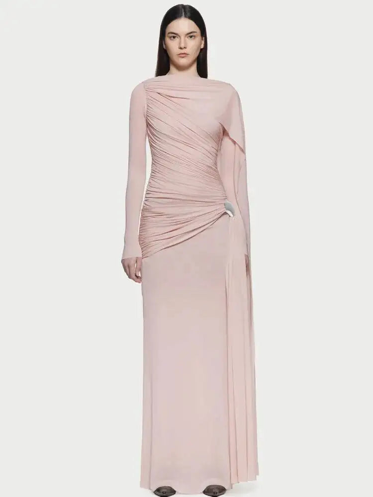 Woman wearing a pink draped dress on a white background