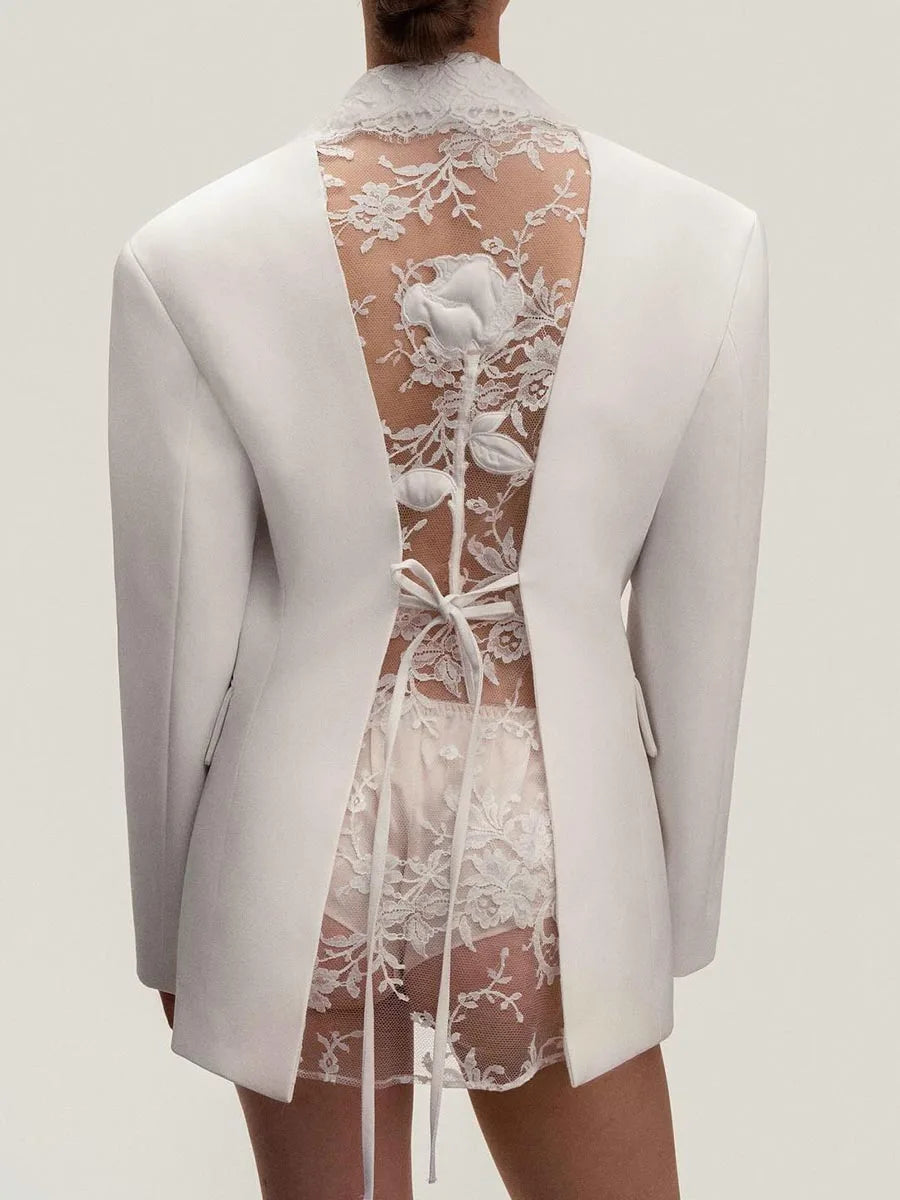 White blazer with floral lace back design on a plain background