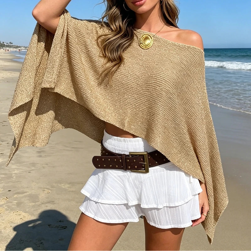 Shimmer asymmetrical poncho knitwear top on a beach background